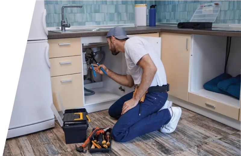 Plumber with Wrench Fixing Kitchen Sink