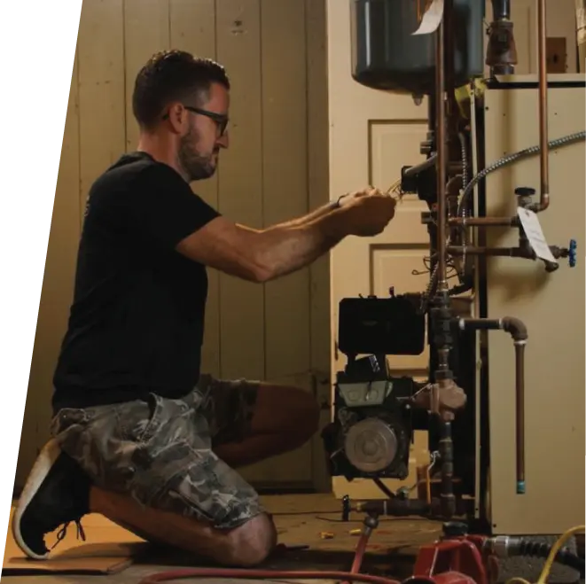 Mazzacone Plumbing technician repairing oil boiler